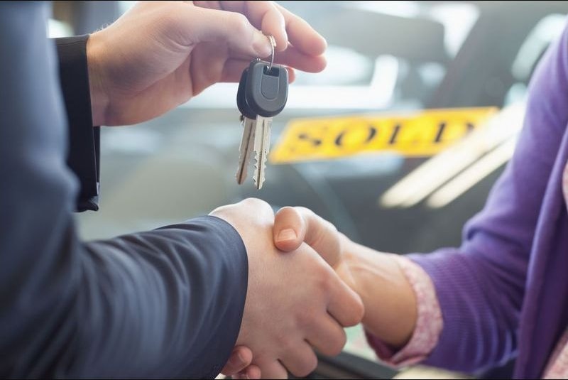 Buyer and seller shaking hands during a private-party car sale